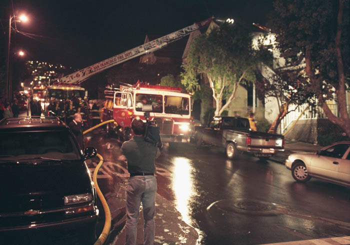 A house burns in Noe Valley, San Francisco. The fire department shows up, people watch.